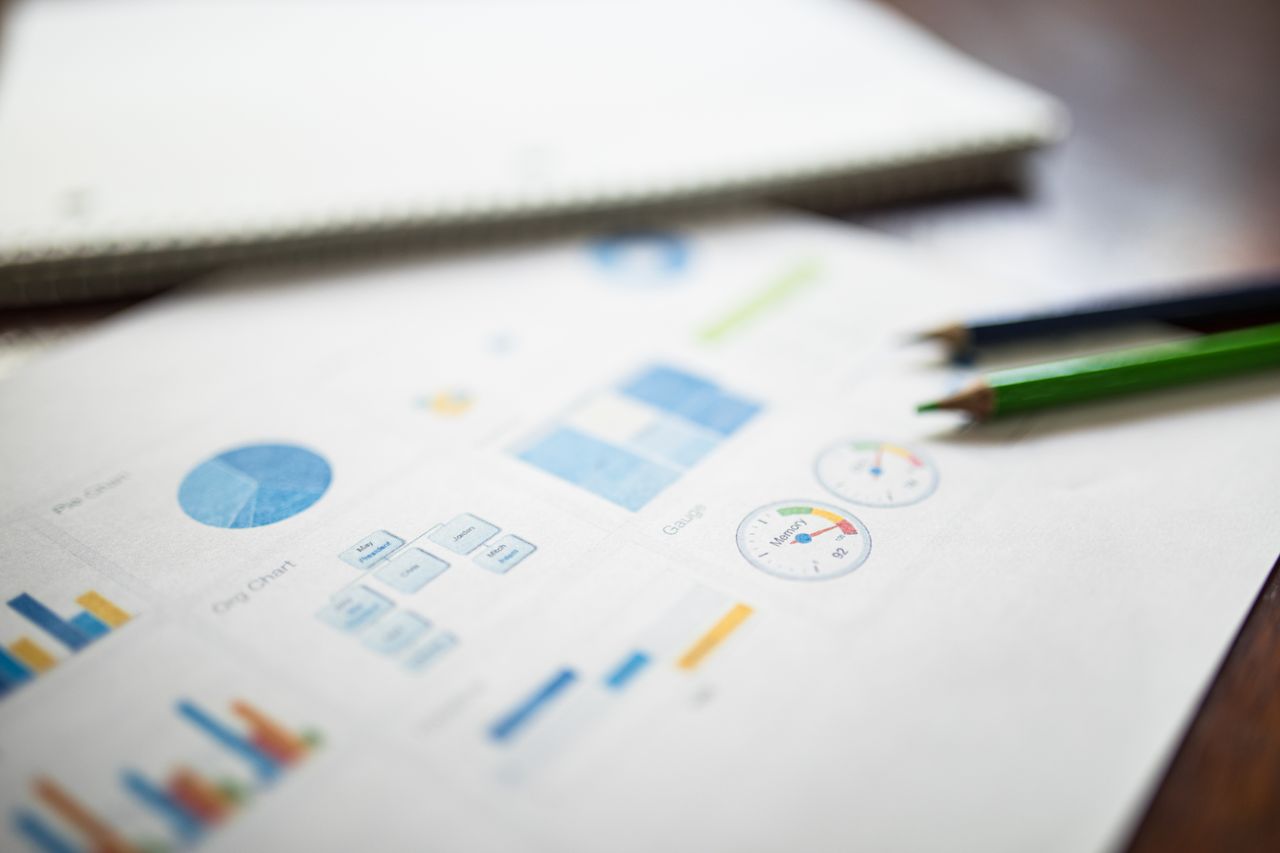 services-01 Illustration of a business financial report featuring various charts and graphs on paper.